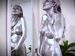 Silver painted milf touching herself in front of a mirror