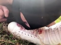 Ballbusting training session outdoors for foot slave